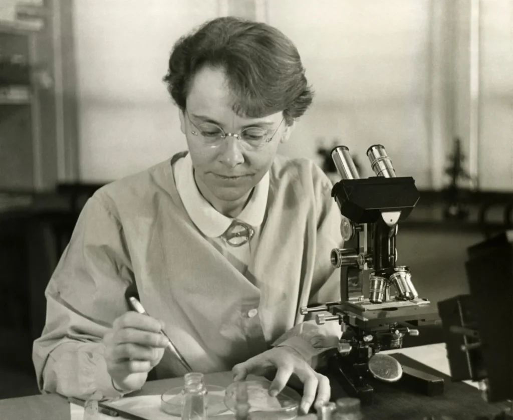 A doctor looking into a microscope in a laboratory